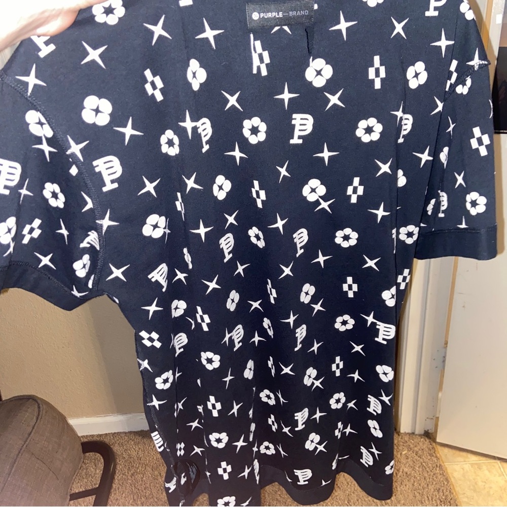 Purple brand shirt with defect. Brand new with a small rip in the top back.